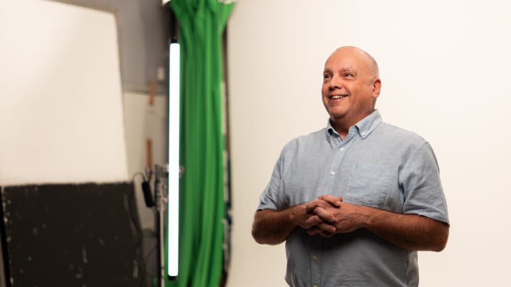 Dementia trainer standing smiling in front of camera