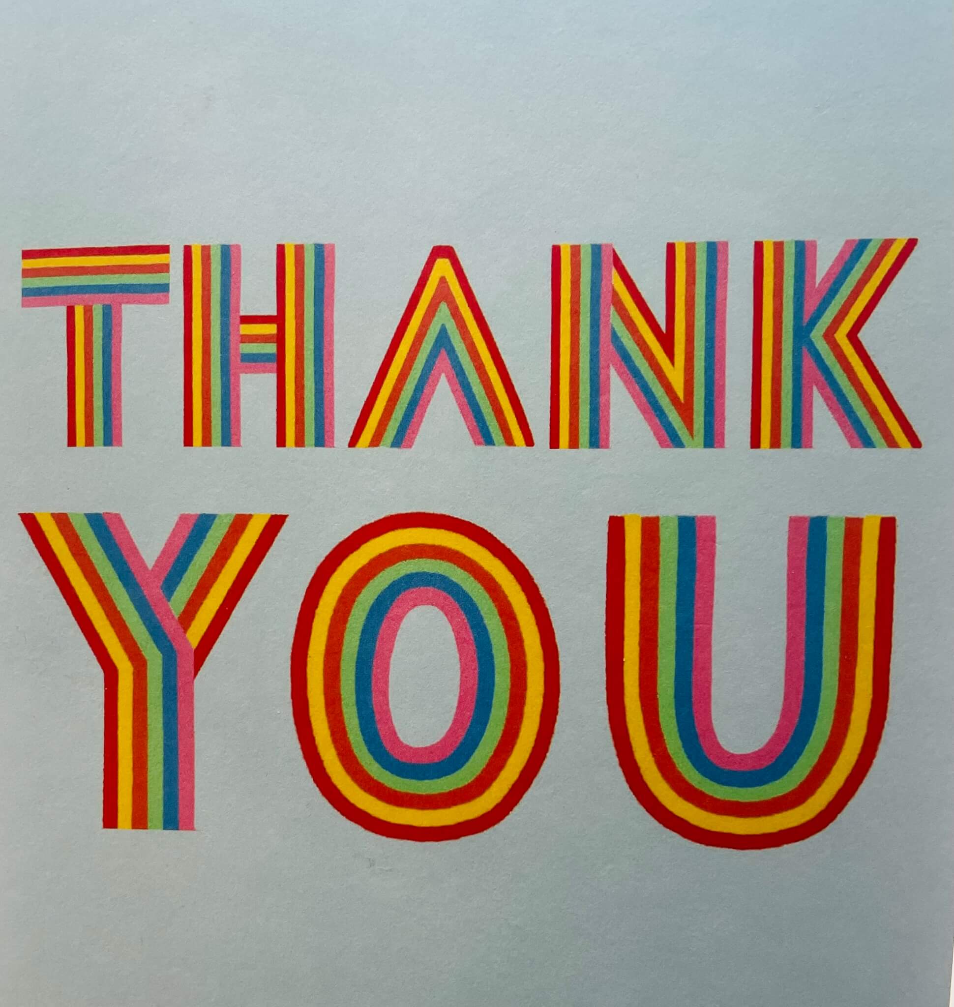 Colorful, striped text reading "THANK YOU" on a light background. - Home Instead
