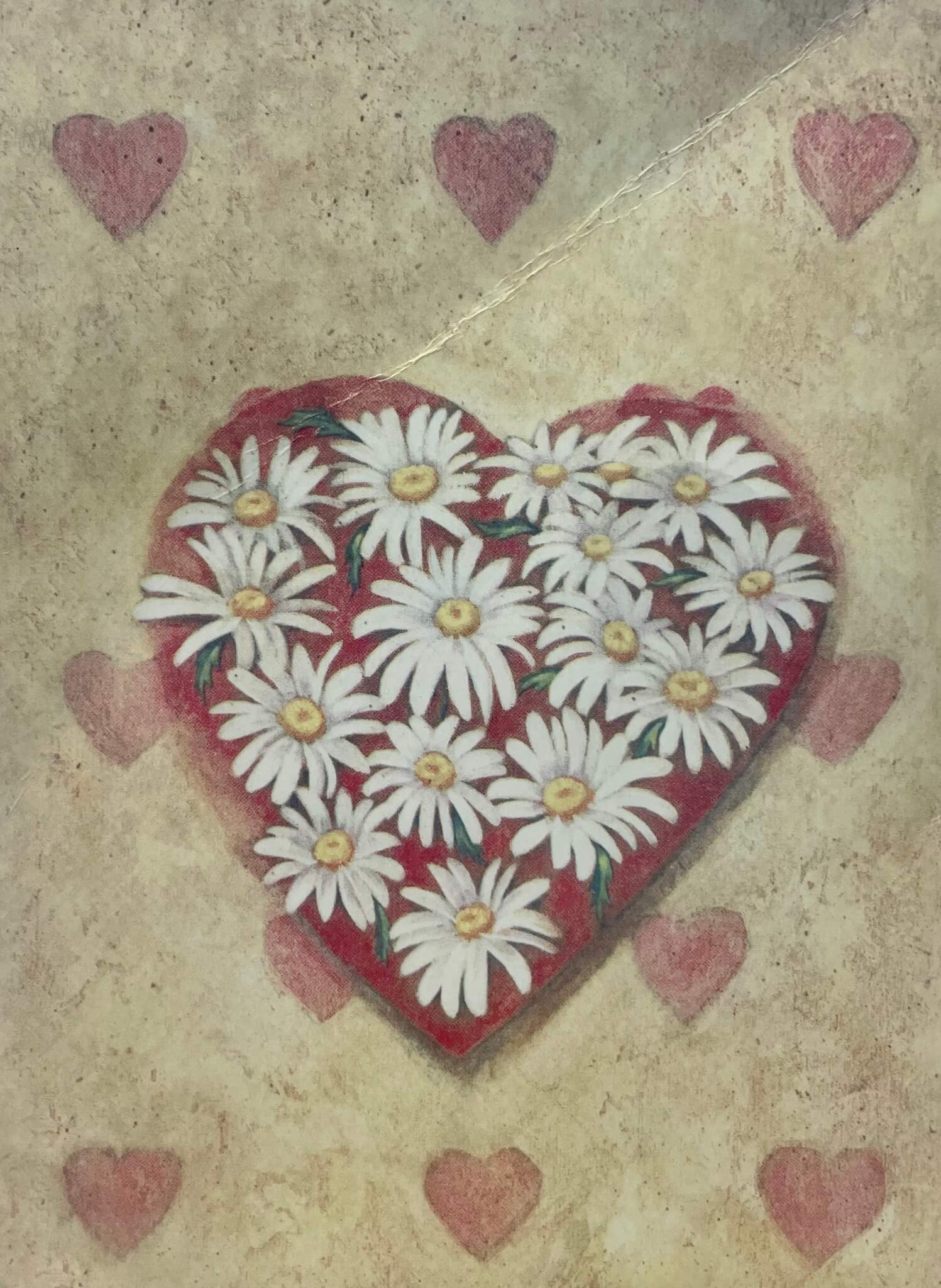 A heart-shaped arrangement of white daisies on a textured background with smaller heart patterns. - Home Instead