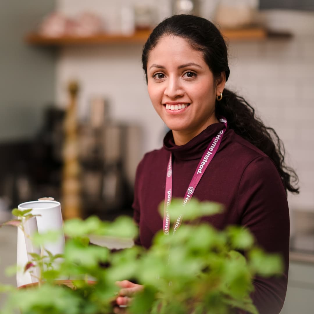 Care Professional pouring a drink and smiling
