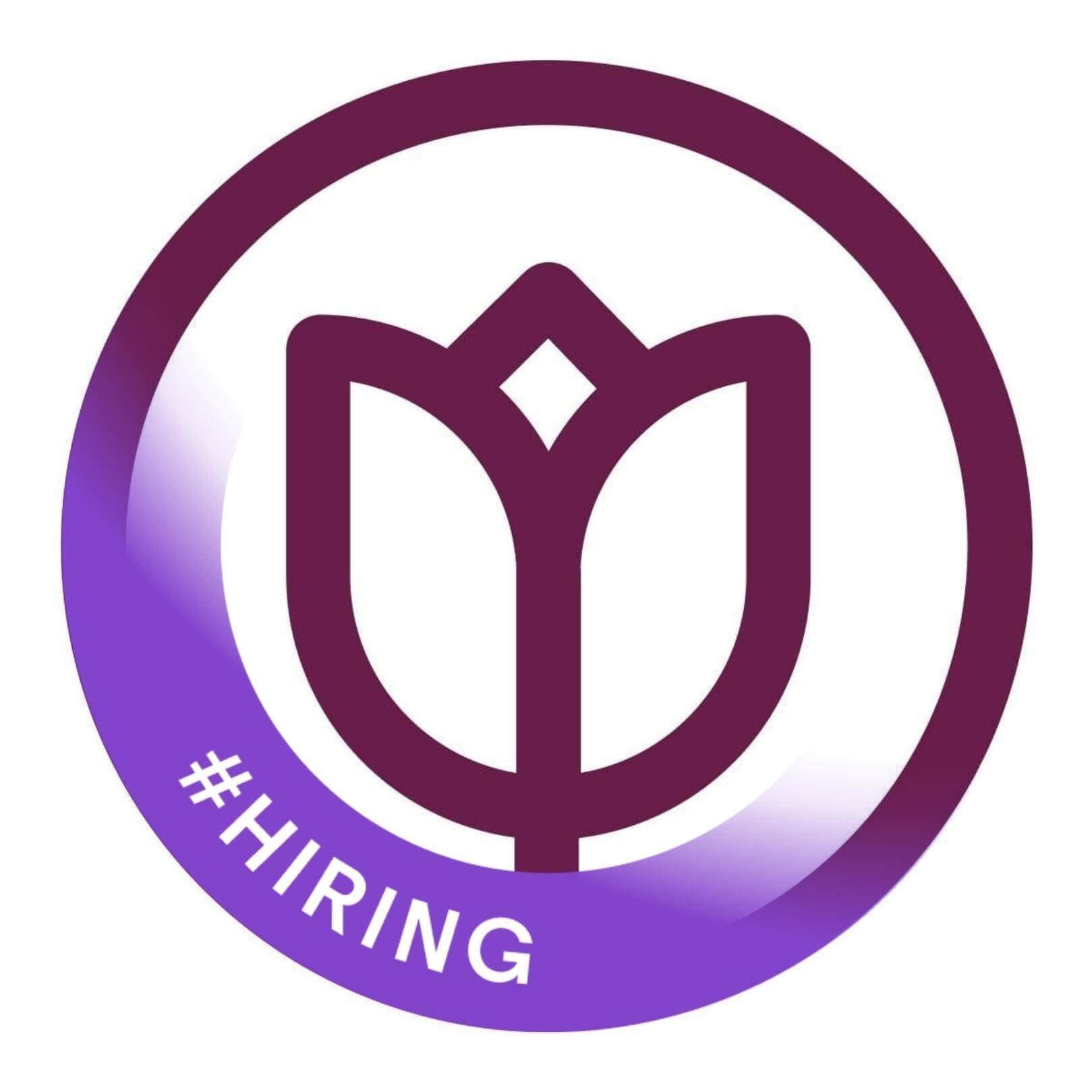 Purple tulip icon within a circle, with "#HIRING" text on a purple ribbon at the bottom left. - Home Instead