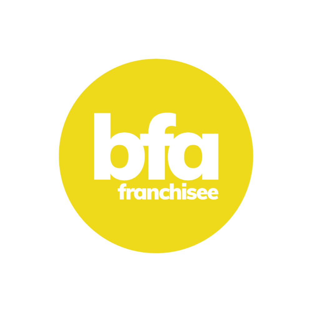 Yellow circle with white text in the center reading "bfa franchisee. - Home Instead