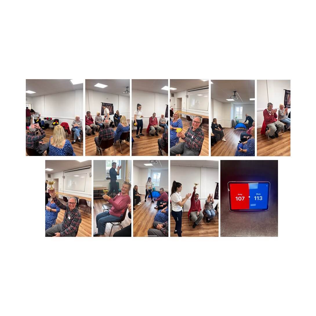 People engaging in group activities indoors, including discussions and games, with a screen displaying scores 107 and 113. - Home Instead