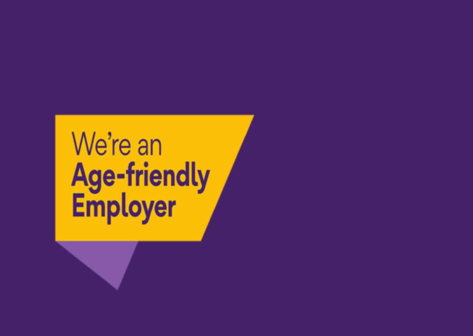 Yellow text on a purple background reads, "We're an Age-friendly Employer" in a yellow geometric shape. - Home Instead