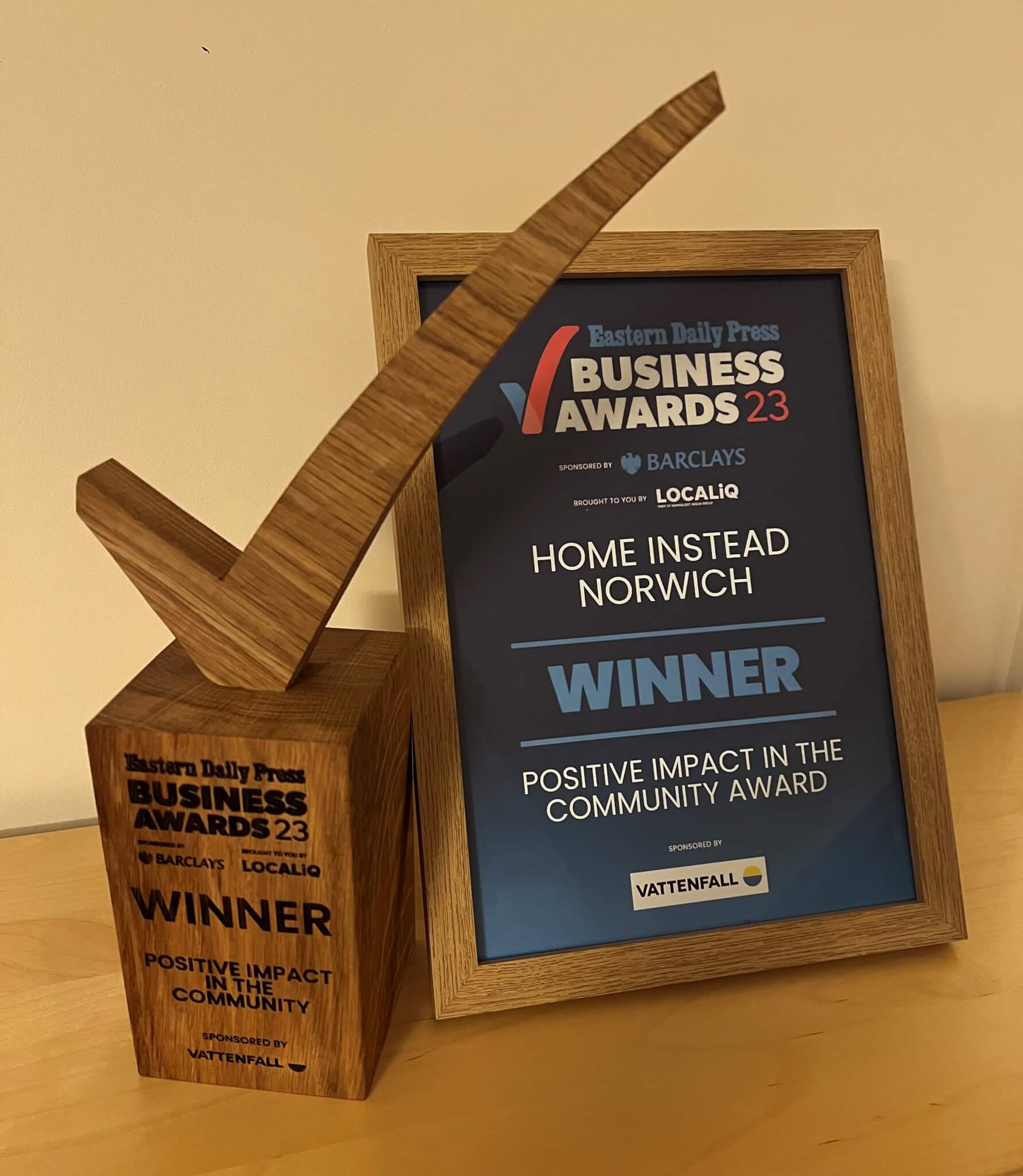 Award plaque and trophy for Home Instead Norwich, winners of the 'Positive Impact in the Community' award at the EDP Business Awards '23. - Home Instead