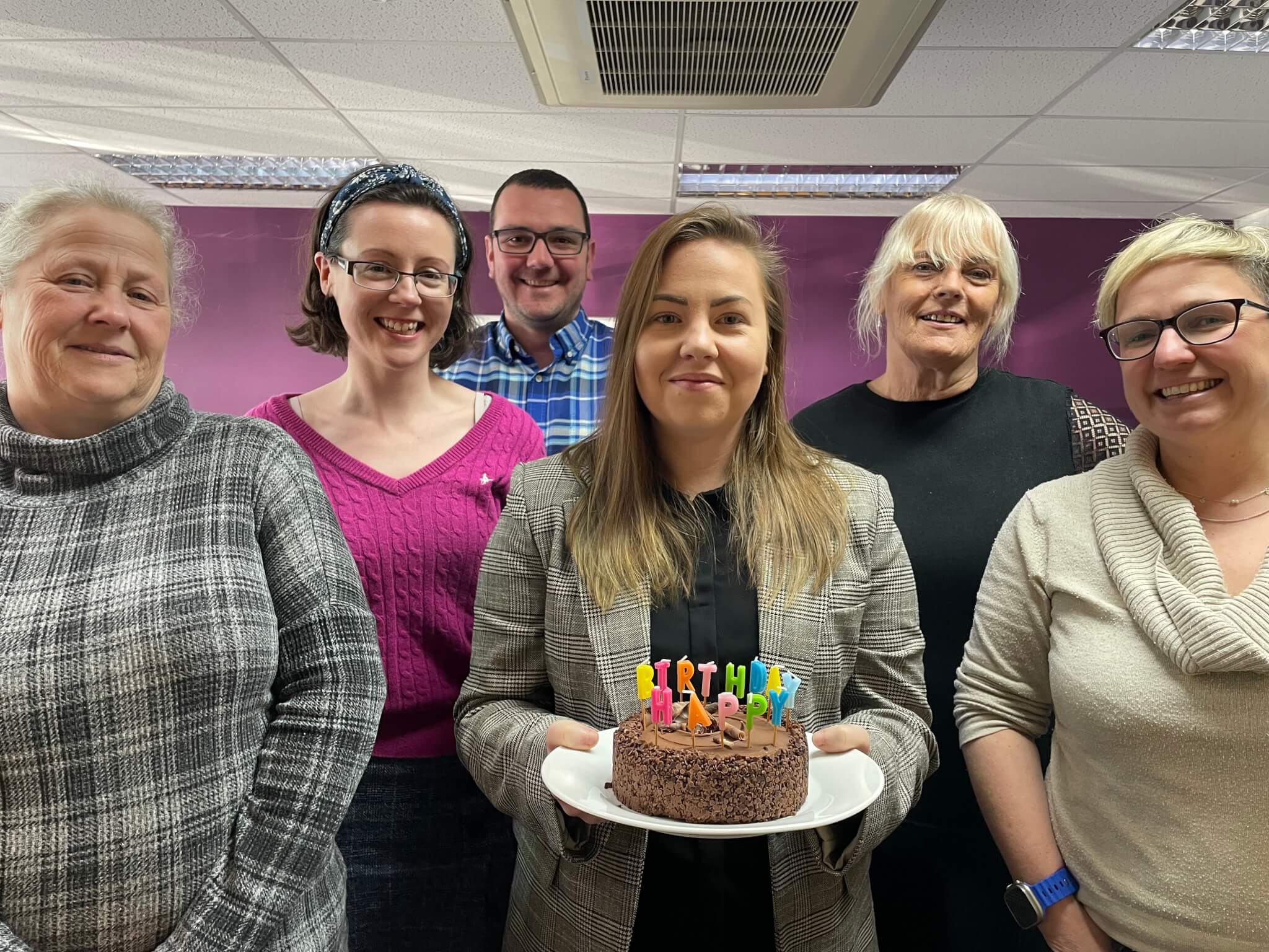 The office team with a birthday cake