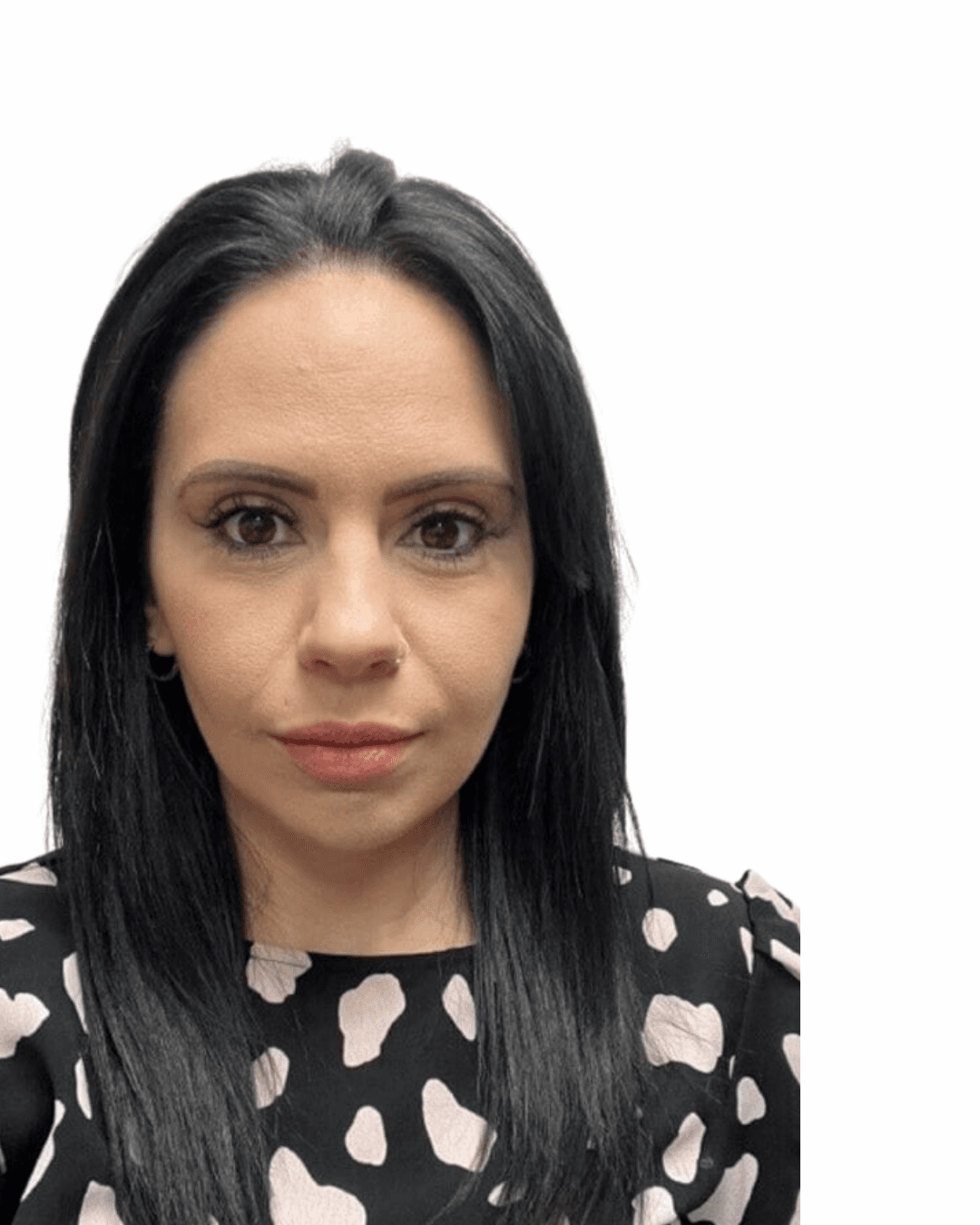 Group photo of seven women standing indoors, smiling, and wearing name badges in front of a "Live well, your way" banner. - Home Instead