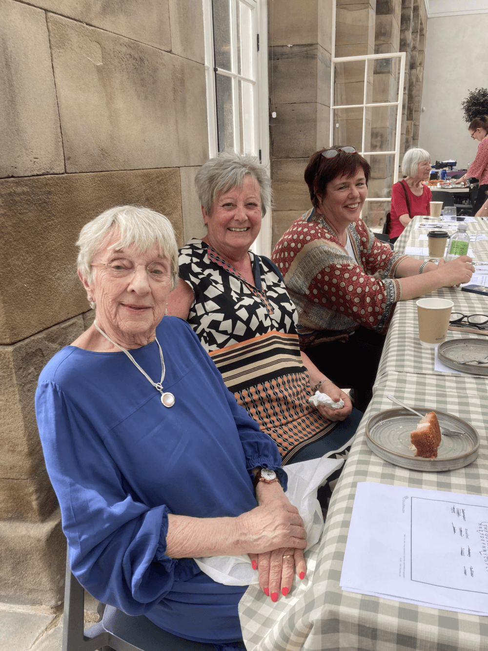 women smiling at community lunch - Home Instead