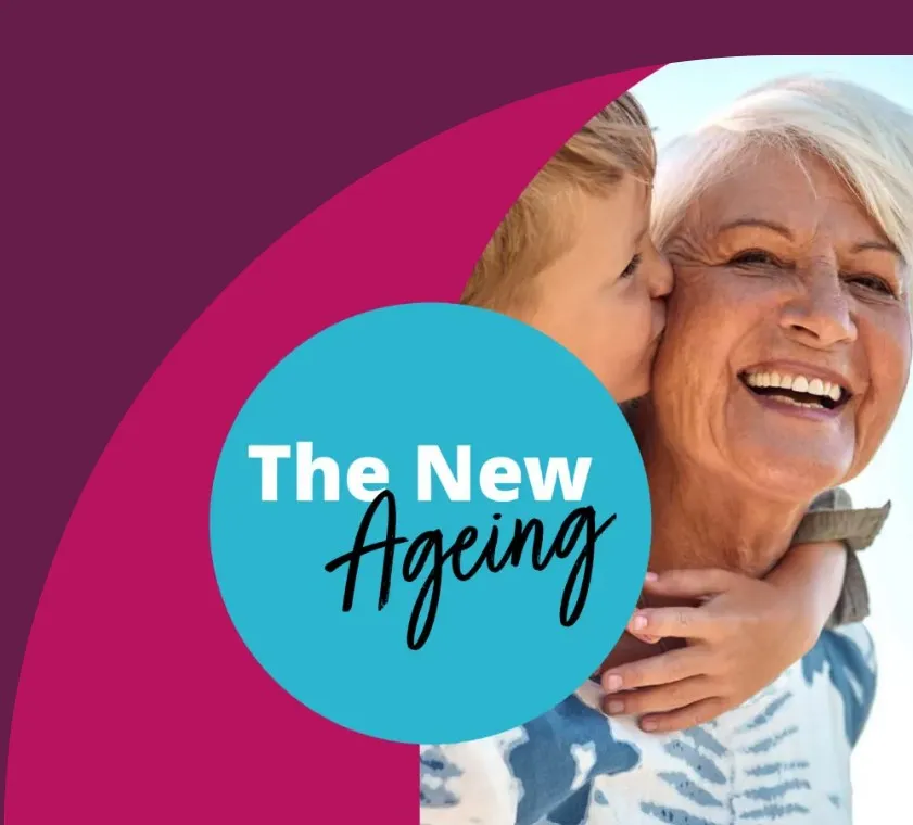 Smiling elderly woman being kissed on the cheek by a young child, with "The New Ageing" text in a blue circle. - Home Instead