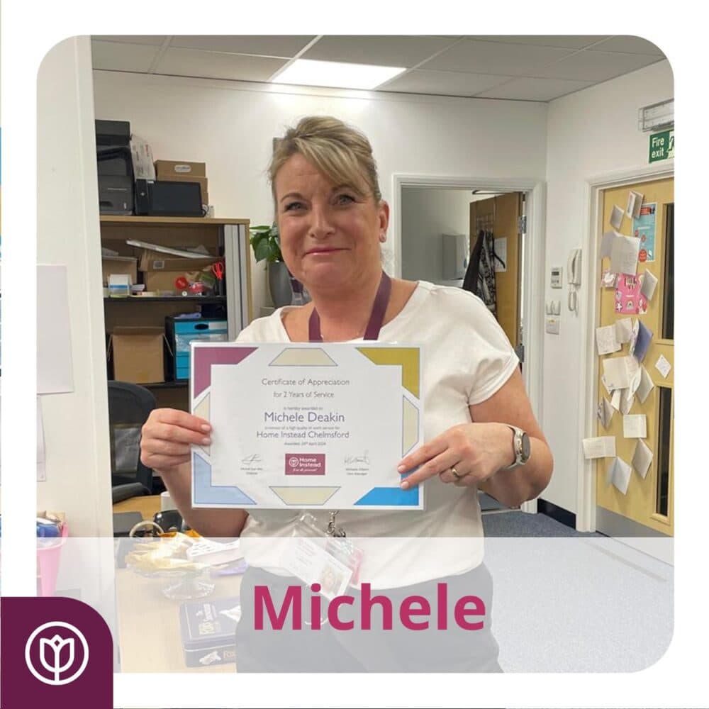 Smiling person holding a Certificate of Appreciation in an office setting. - Home Instead
