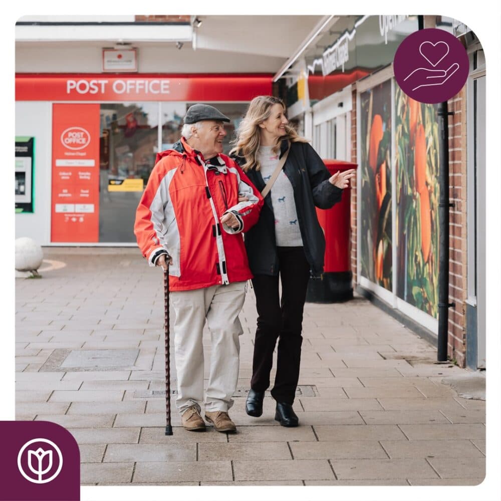 A lovely carer going for a gentle walk with a client to the local shops