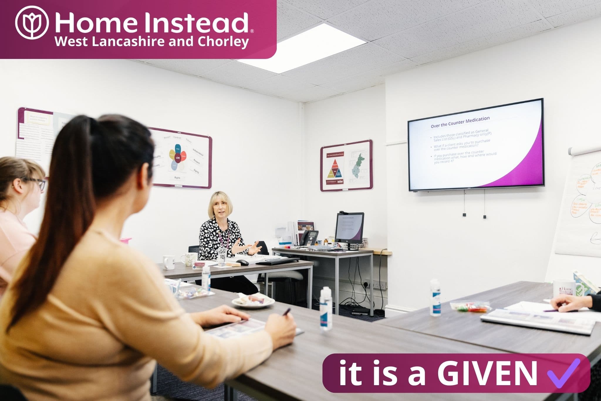 home instead west lancashire and chorley care professionals in a classroom, being taught through high-quality, accredited training sessions