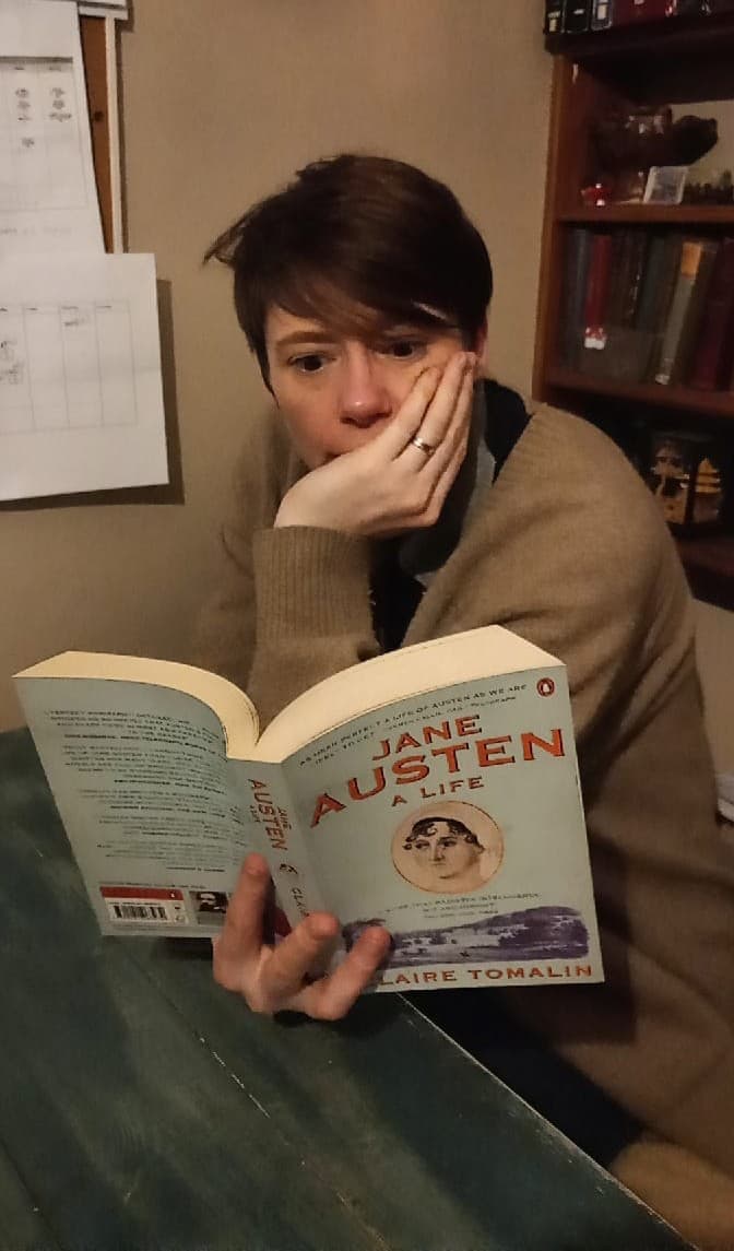 Care Pro reading a book titled Jane Austin