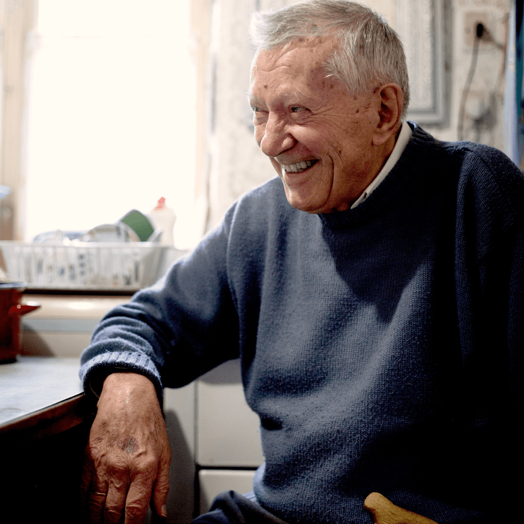 Elderly Man smiling in his kitchen at home