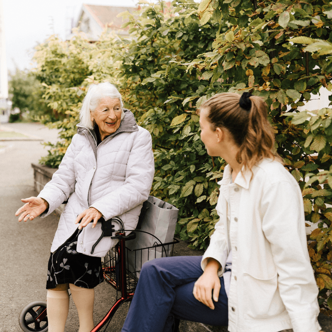 Elderly lady with a younger lady talking outdoors