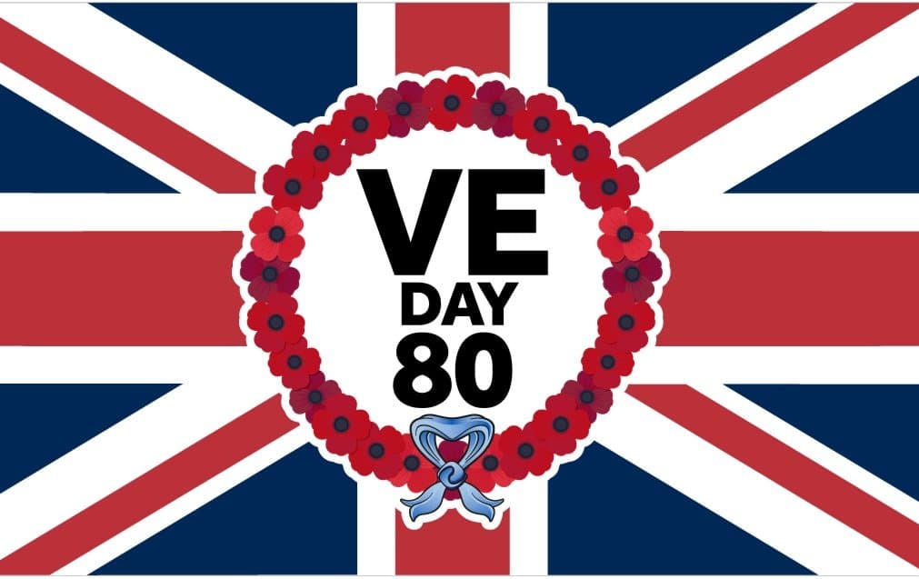 “Community members gathered in Sawbridgeworth on 8th May 2025 to commemorate the 80th anniversary of VE Day with flags and wreaths.”