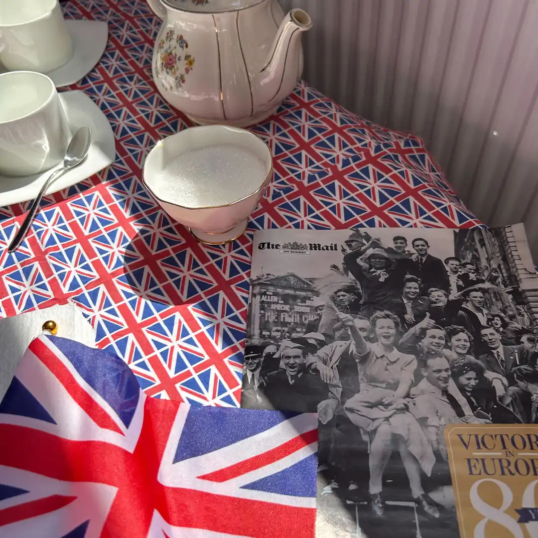 Table with tea set and union jack as part of VE Day celebrations at Home Instead Farnborough, Farnham and Fleet