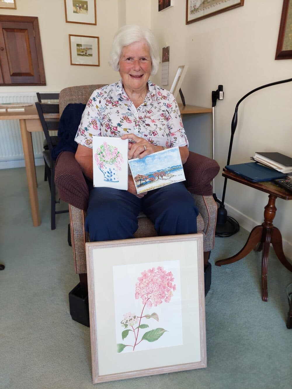 Female client holding her paintings