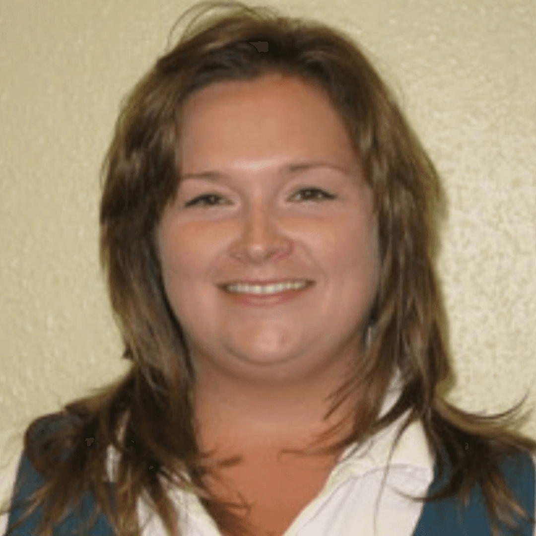 a woman with shoulder length brown blonde hair, smiling with a white shirt