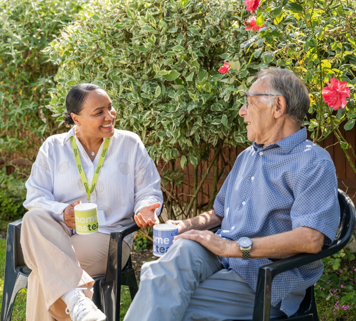 Chatting together while having coffee in the garden in the summer season