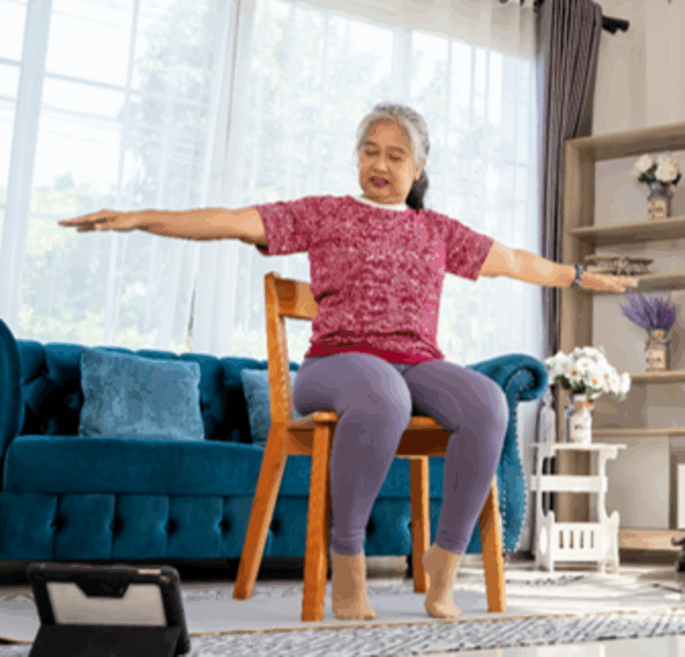 Home Instead Senior Care Client enjoys chair exercises at home