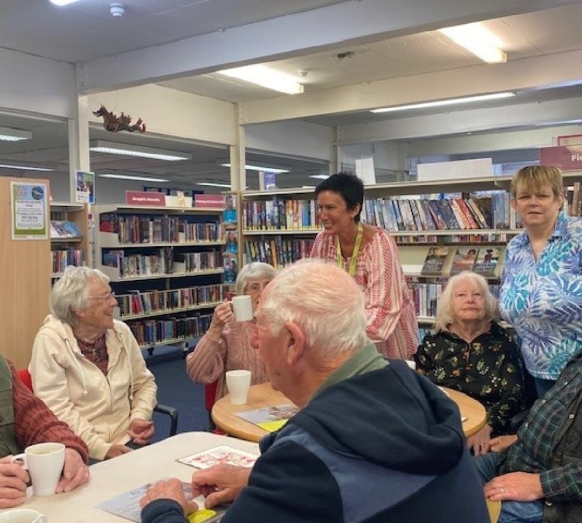 Many people sitting and chatting and happy and laughing