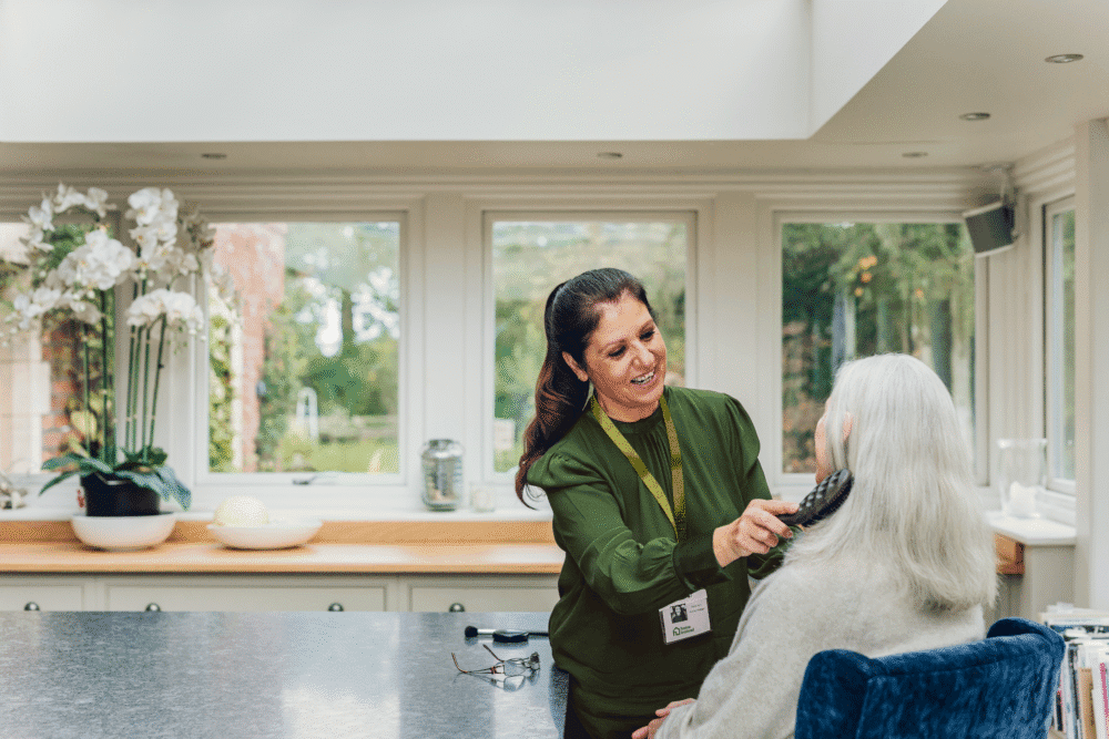 Home Instead Care Professional brushing the hair of a elderly woman client