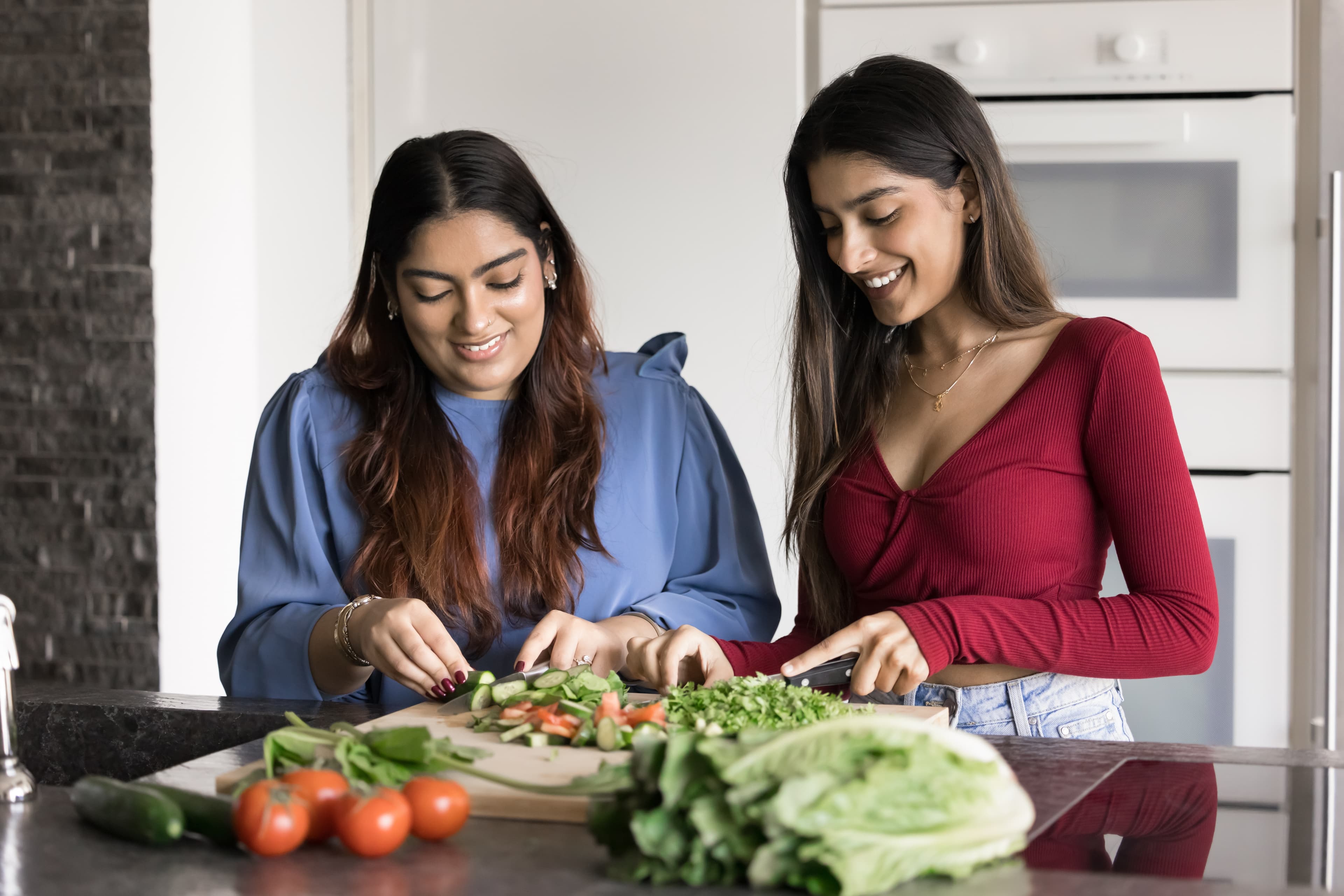 Home Instead Care Professional helps a younger adult with meal preparation