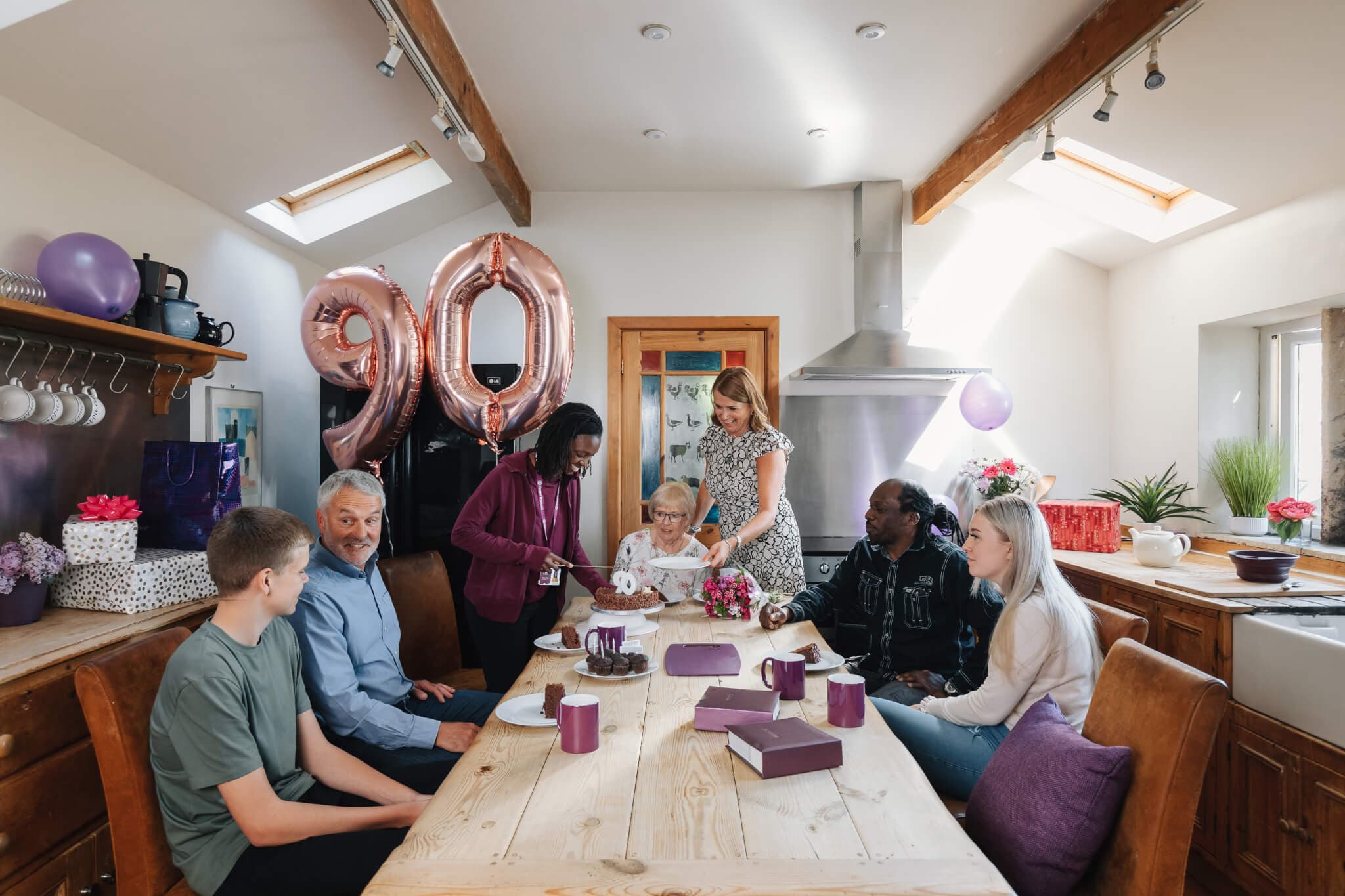 Home Instead Carer assisting client to enjoy family birthday