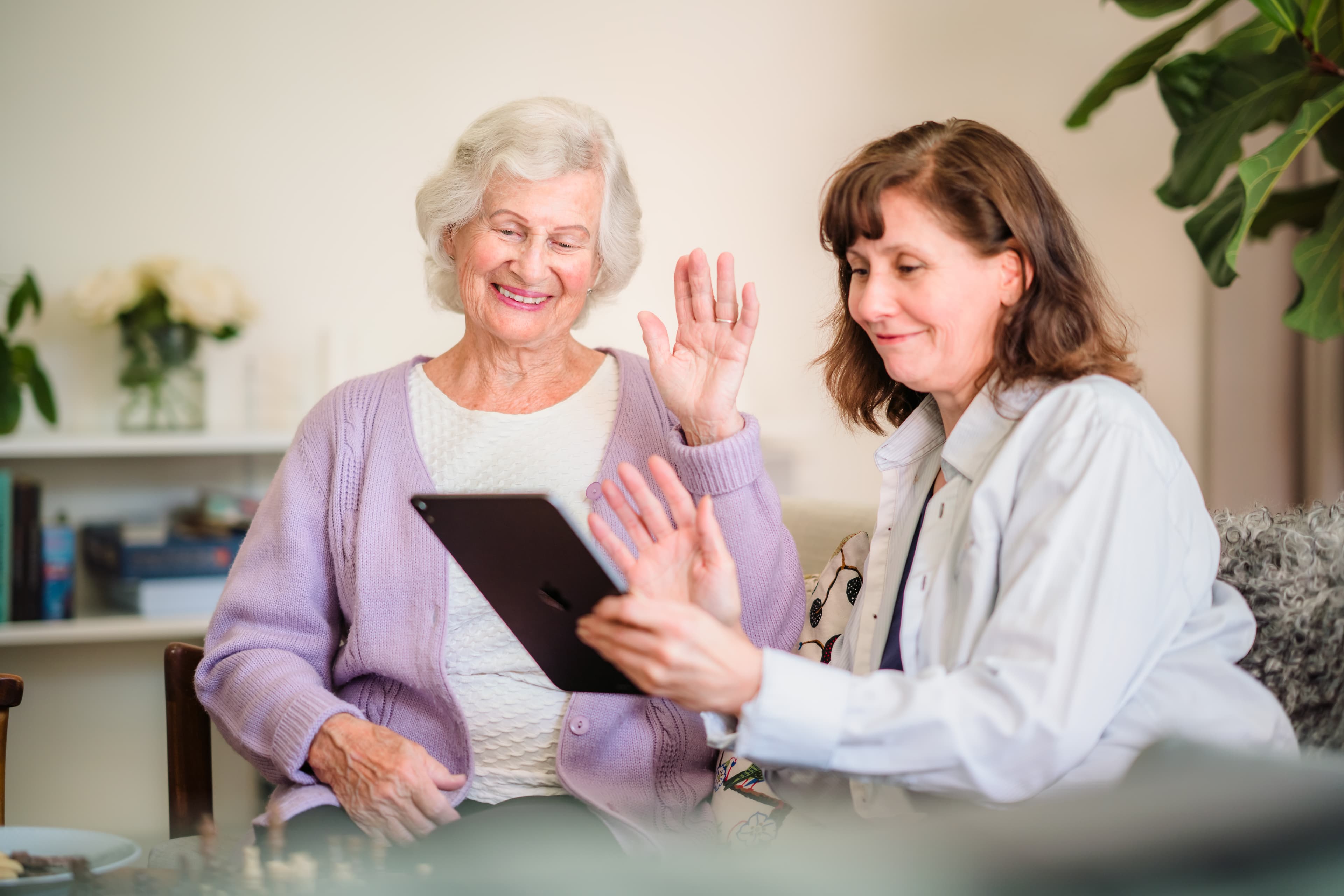 Client with Care Professional on a call on tablet - Home Instead