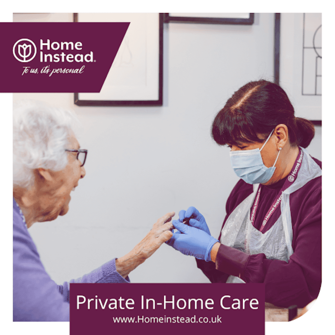 A caregiver assists an elderly woman during a private in-home care visit, both wearing face masks. - Home Instead