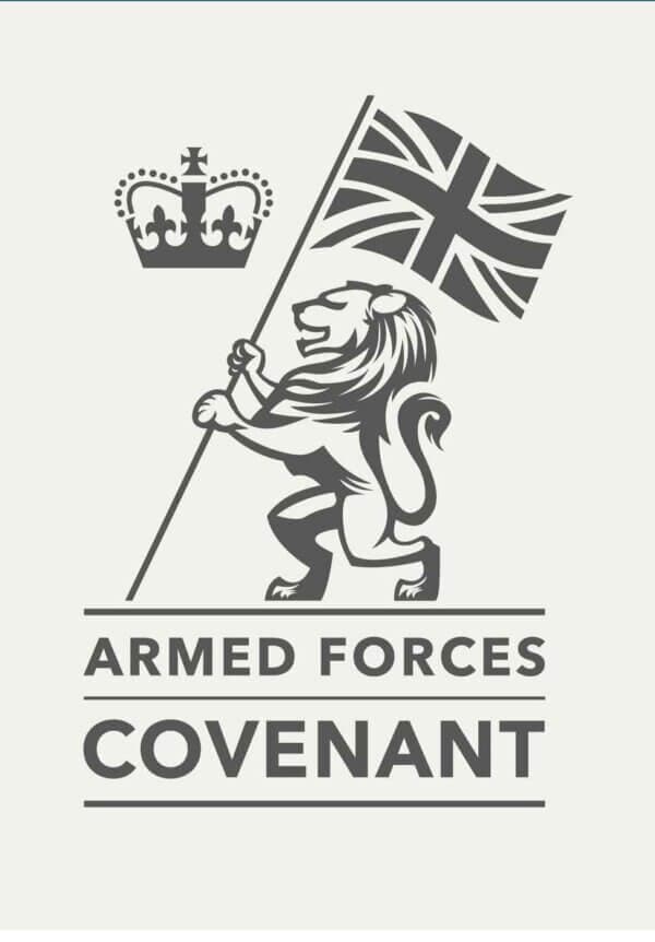 A lion holding a flag with a crown above it and the text "Armed Forces Covenant" below. - Home Instead
