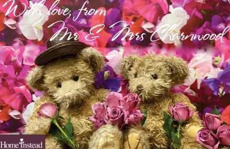 Two teddy bears holding pink roses with a flowery background. Text reads "With love, from Mr & Mrs Charnwood. - Home Instead