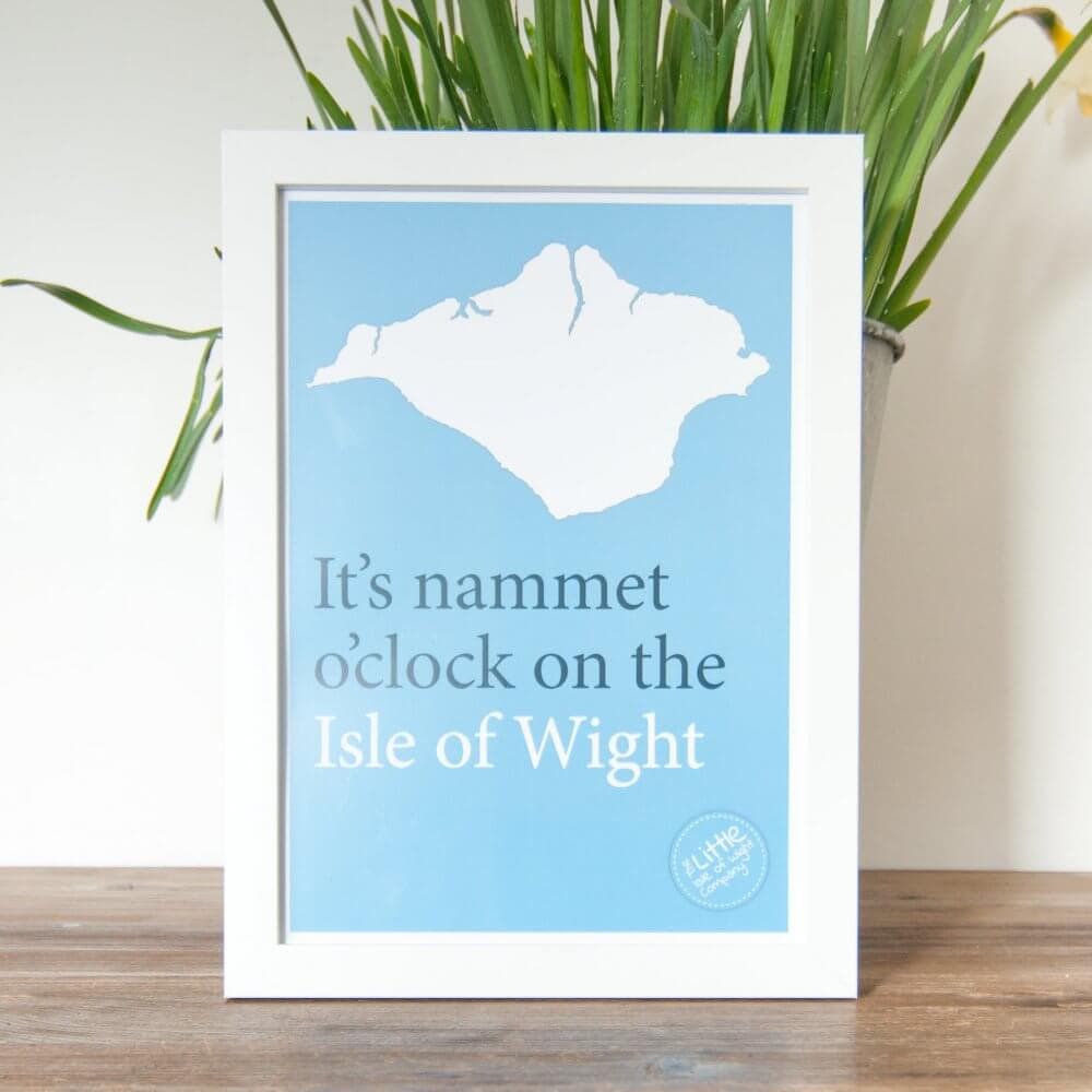 Framed sign with Isle of Wight silhouette reads, "It's nammet o'clock on the Isle of Wight" on a blue background. - Home Instead