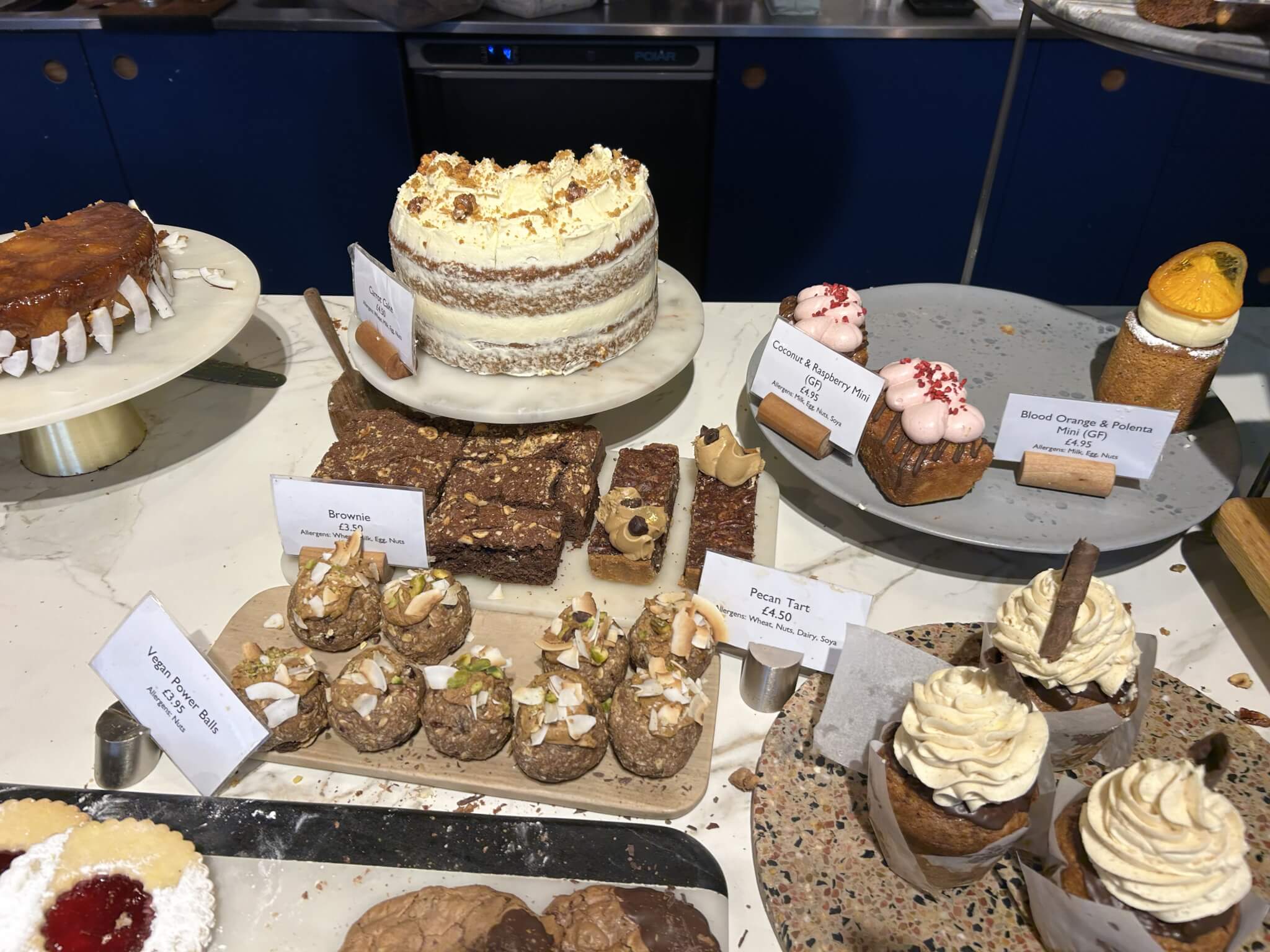 Home Instead Basingstoke picture of assorted cakes, brownies, cupcakes, and other pastries displayed at The Street Bakeshop, Old Basing, Basingstoke