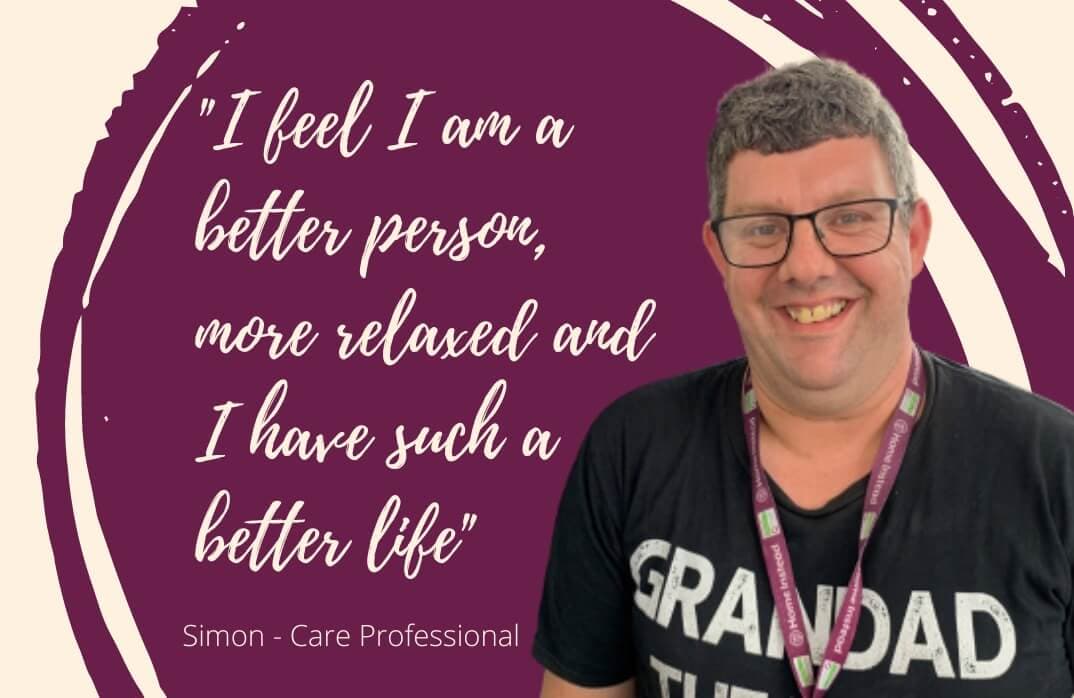 Man in a black "Grandad" shirt and lanyard, smiling next to quote on a maroon background that reads, "I feel I am a better person. - Home Instead