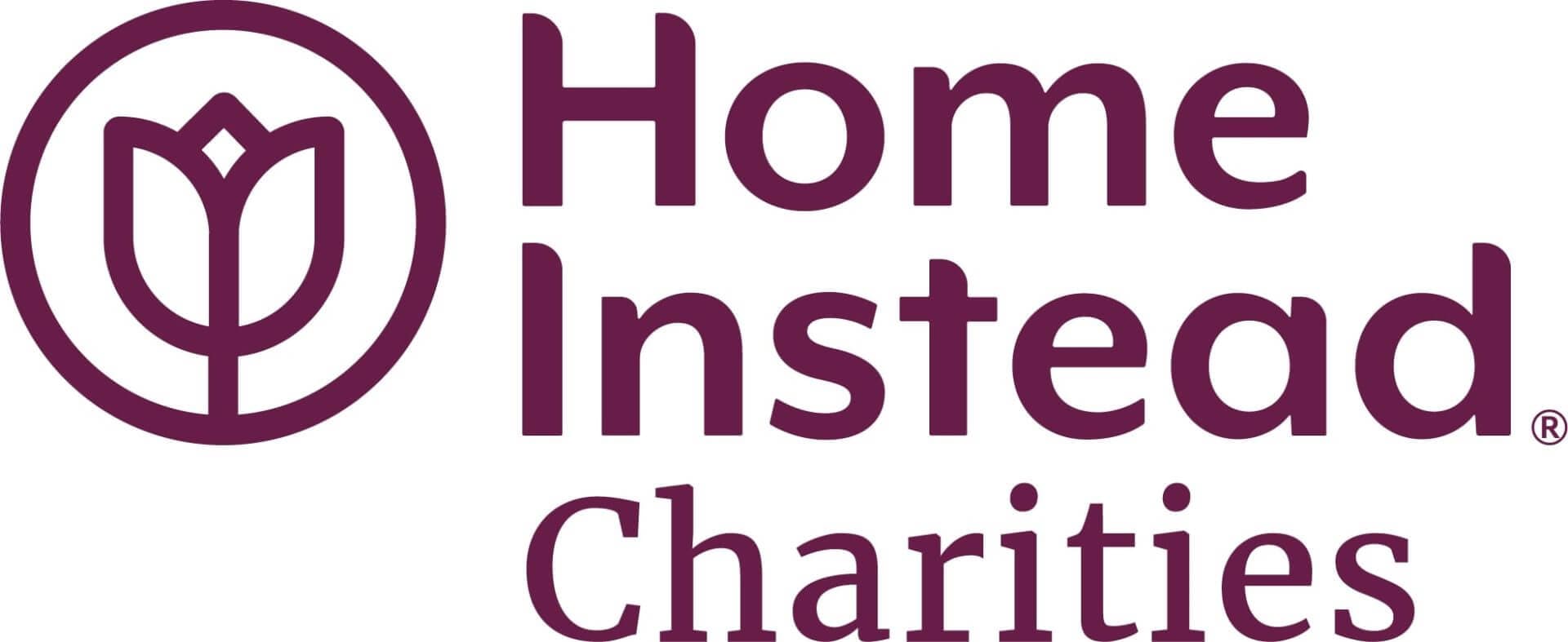 Home Instead Charities logo with a stylized tulip icon accompanied by the text "Home Instead Charities" in purple. - Home Instead