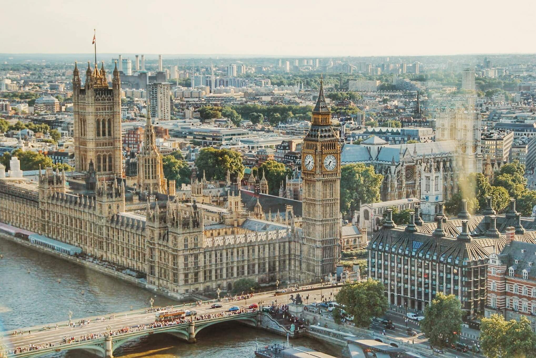Aerial view of the Palace of Westminster and Big Ben in London, with the River Thames in the foreground. - Home Instead