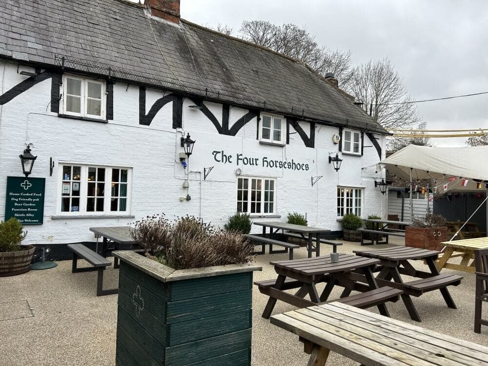 Home Instead Basingstoke picture of outdoor seating area at The Four Horseshoes pub with picnic tables