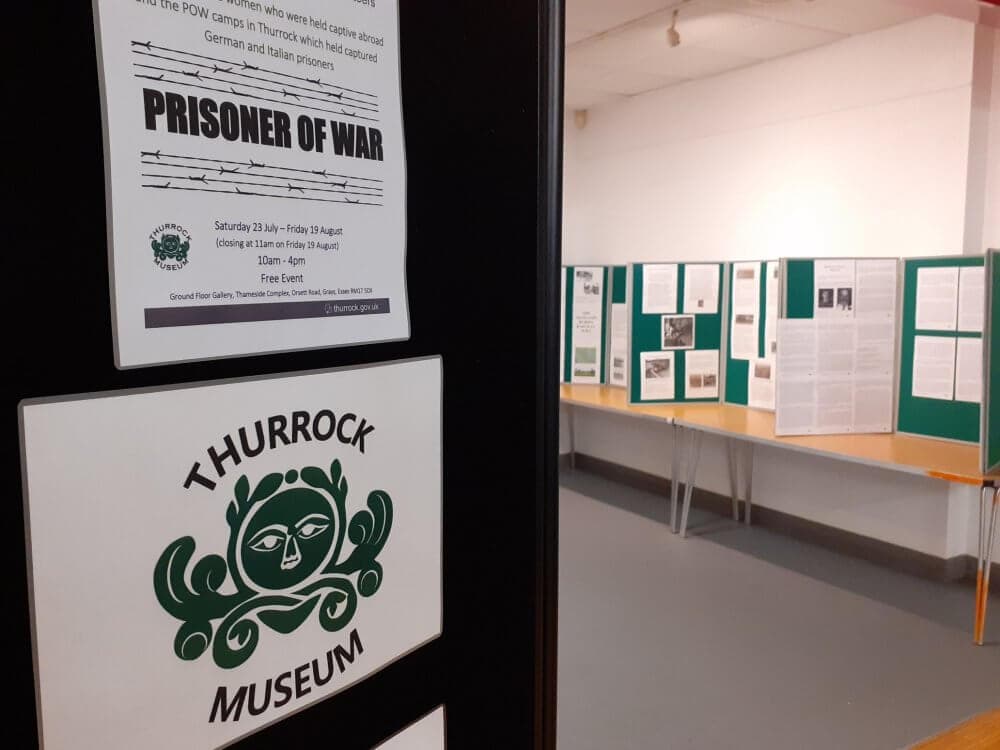Exhibit at Thurrock Museum featuring a "Prisoner of War" display with information panels and posters on the walls. - Home Instead
