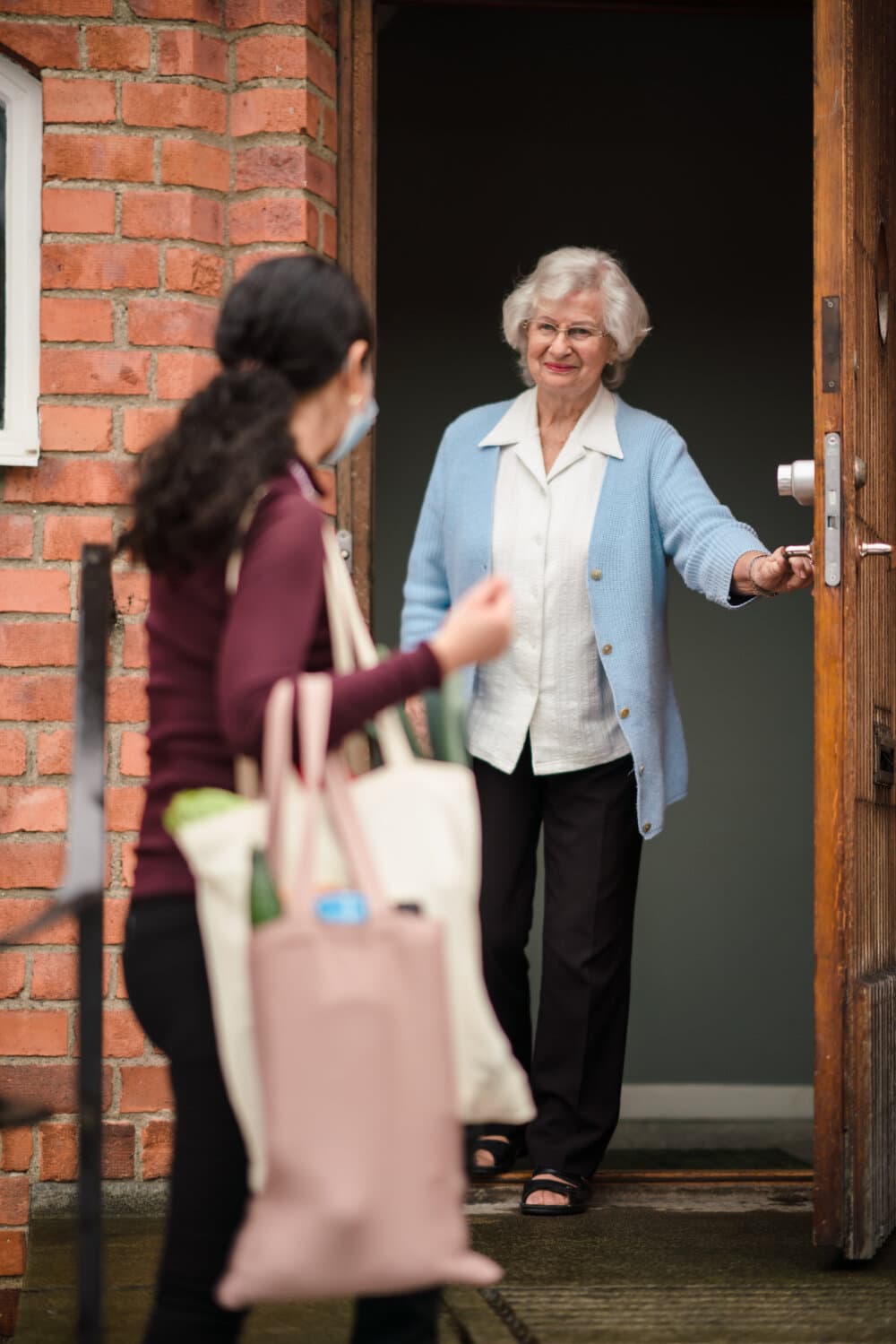 client opening door for Care Professional - Home Instead