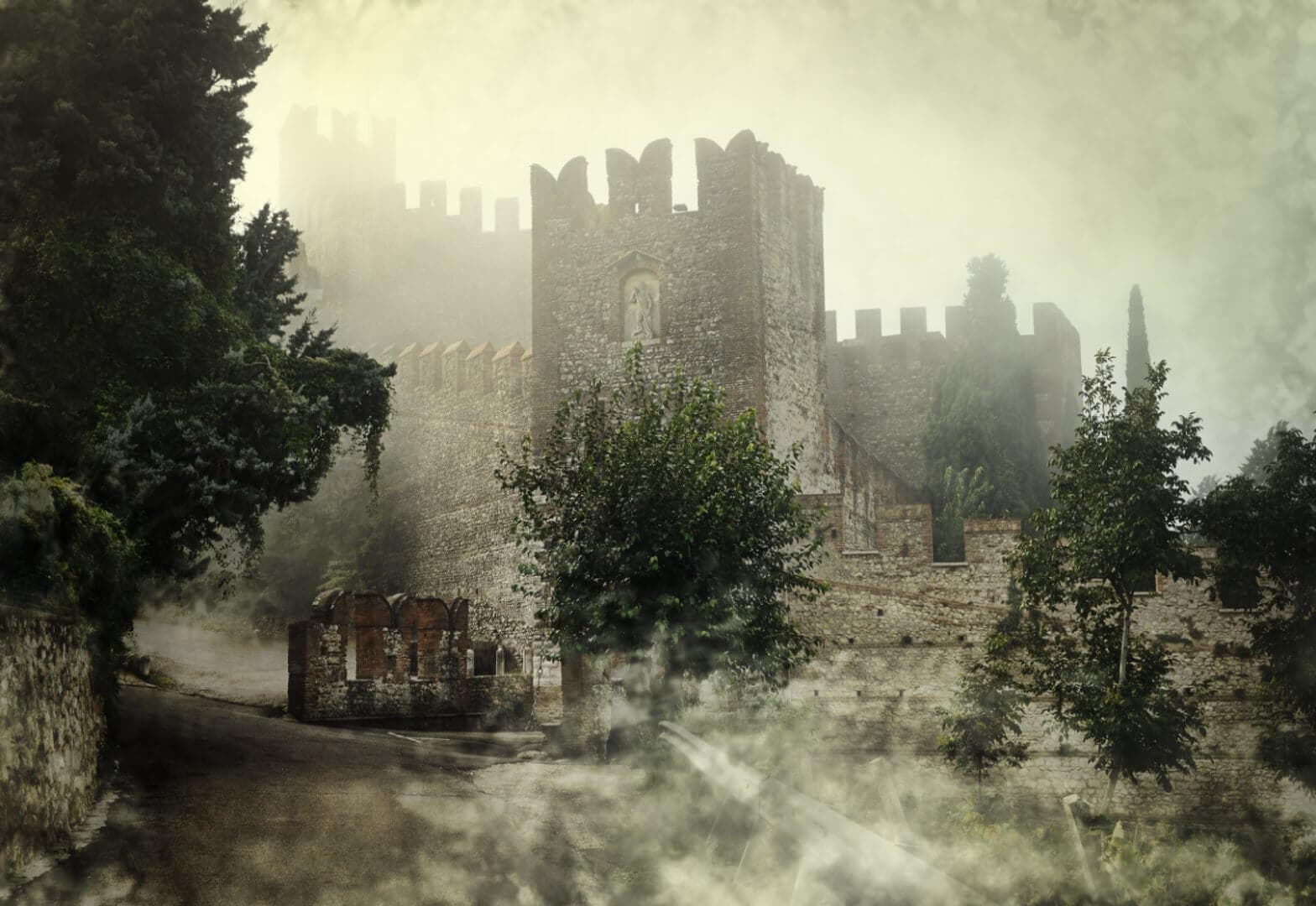 Misty medieval castle surrounded by trees and stone walls, with a foggy path leading to its entrance. - Home Instead