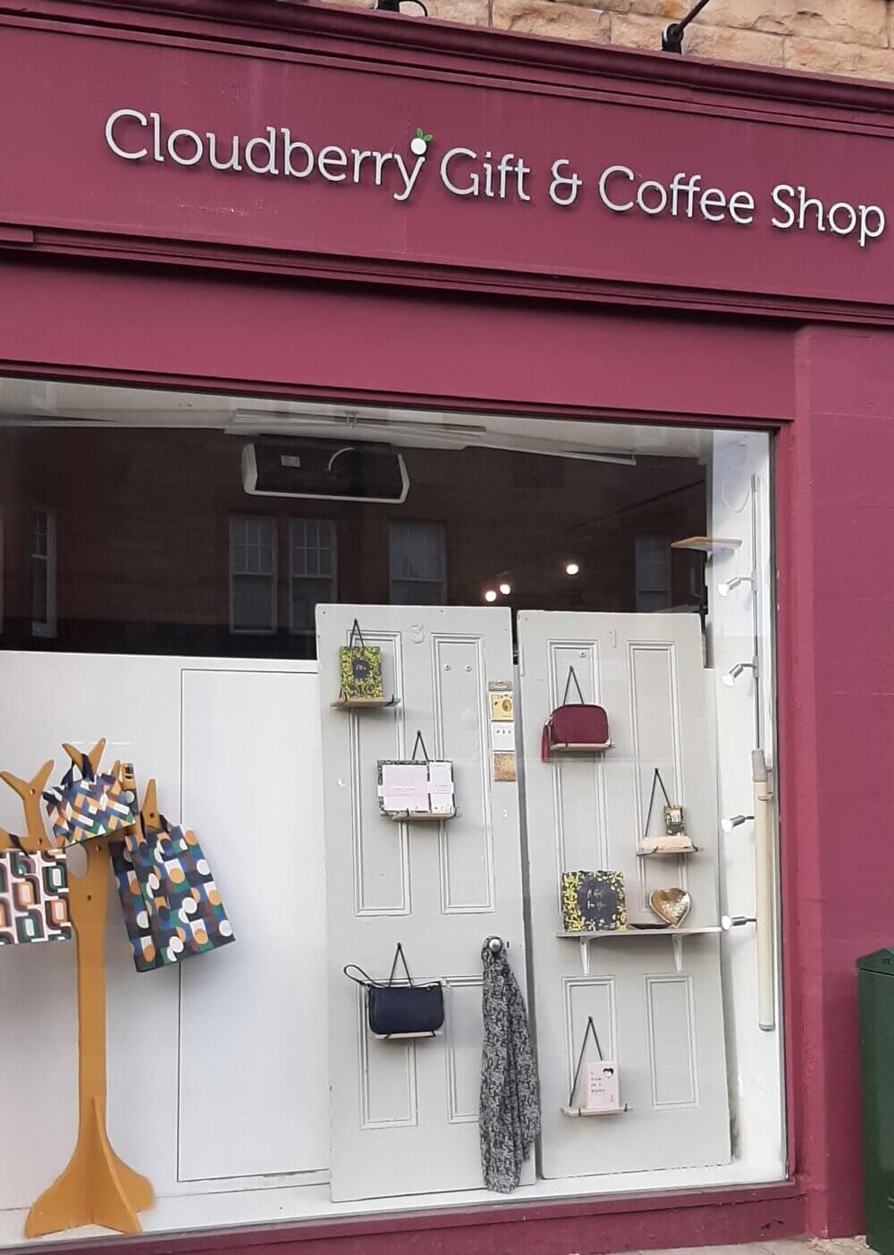 Storefront of Cloudberry Gift & Coffee Shop with bags and gifts displayed in the window. - Home Instead