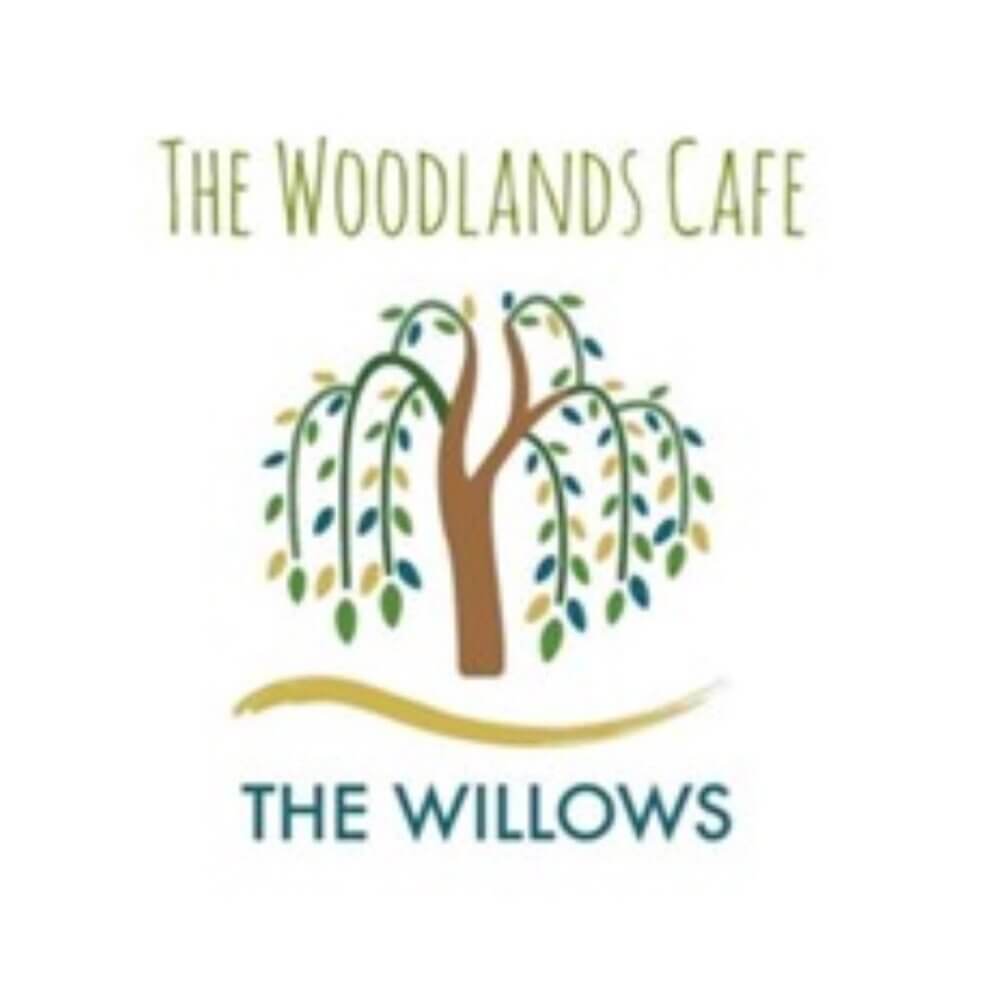 The Woodlands Cafe logo featuring a weeping willow tree with text "The Willows" beneath it. - Home Instead