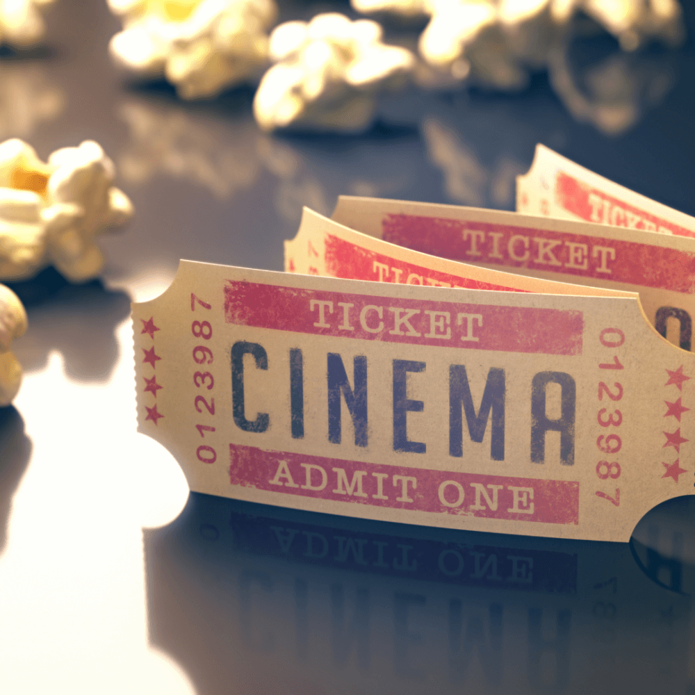 Close-up of cinema tickets and popcorn on a glossy surface. - Home Instead