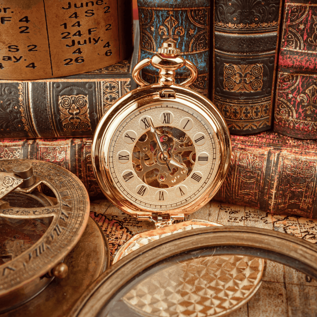 An antique pocket watch, magnifying glass, and old books are arranged on a vintage map. - Home Instead