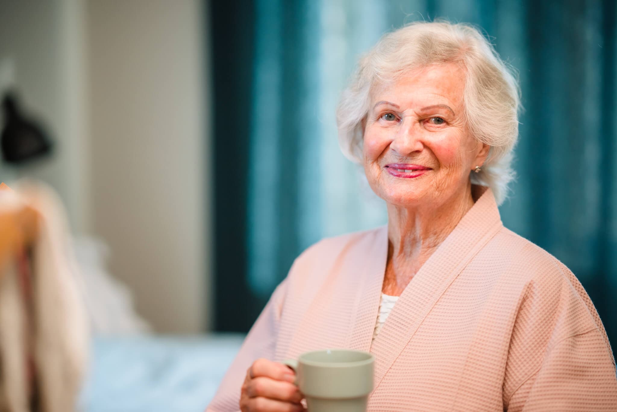 An elderly woman receiving compassionate care from Home Instead Leeds Central in Leeds. This image highlights the personal touch and dedication of our caregivers, who provide live-in care, personal support, and companionship. Our services ensure that your loved ones experience comfort, respect, and high-quality care in the familiar and safe environment of their own home.