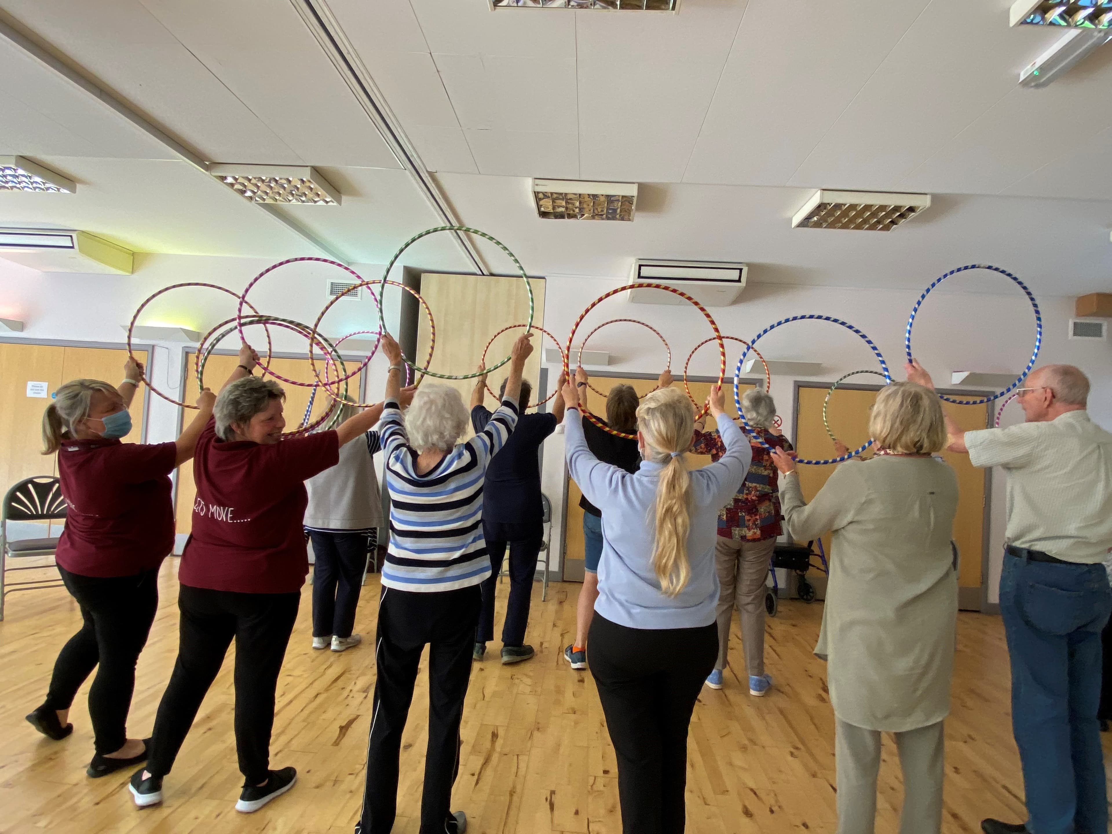 Let's Move exercise class participants exercising with hoops