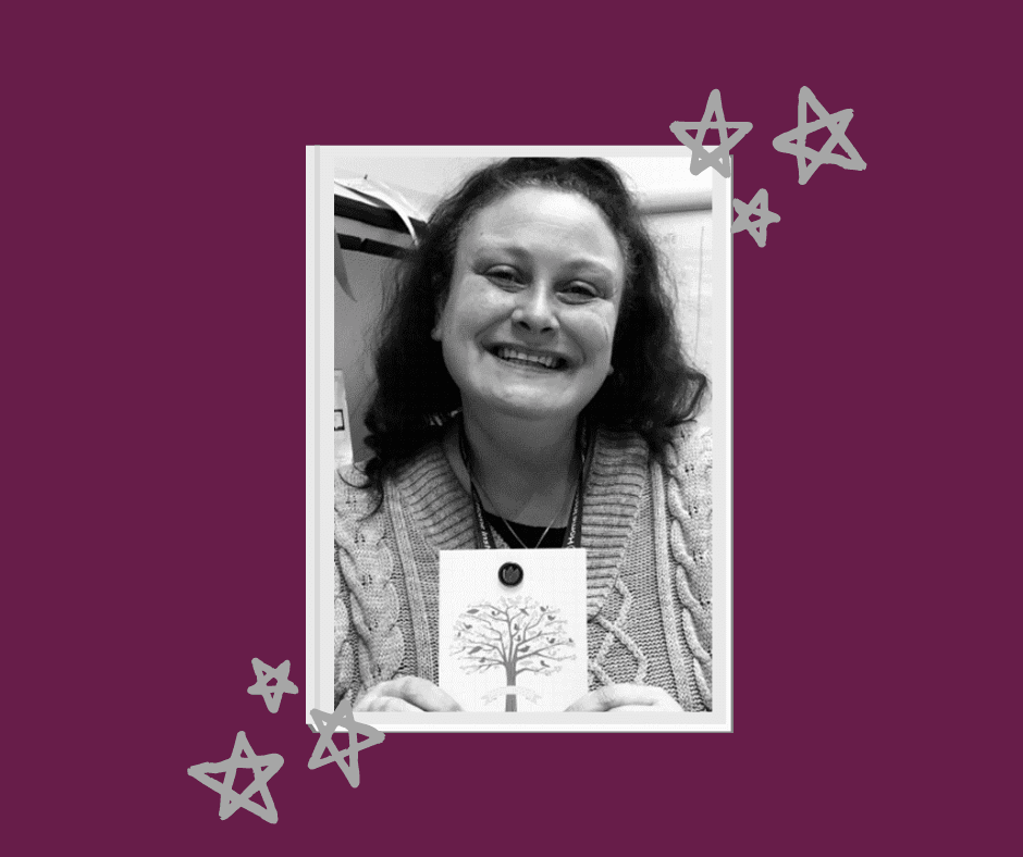 Black-and-white photo of a smiling person holding a card with a tree design, set against a purple background with stars. - Home Instead