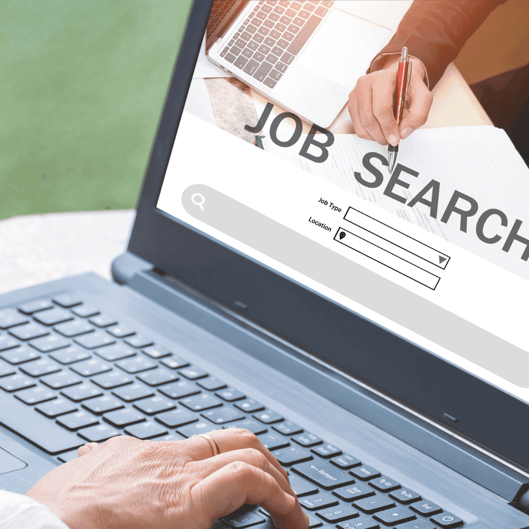 Person typing on a laptop displaying a job search page, ready to enter job type and location. - Home Instead